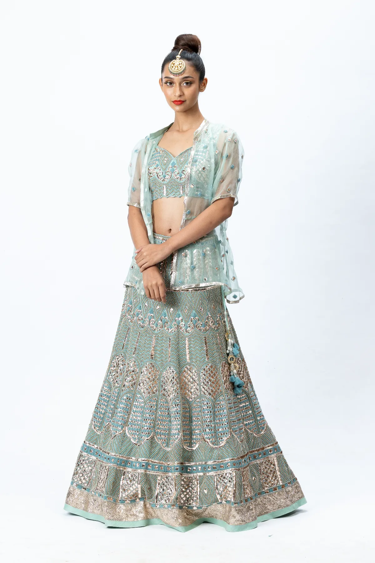 Mint Green Hand-embroidered Lehenga paired with Hand-embroidered Blouse, Hand-embroidered Dupatta and Hand-embroidered Jacket with Buttis