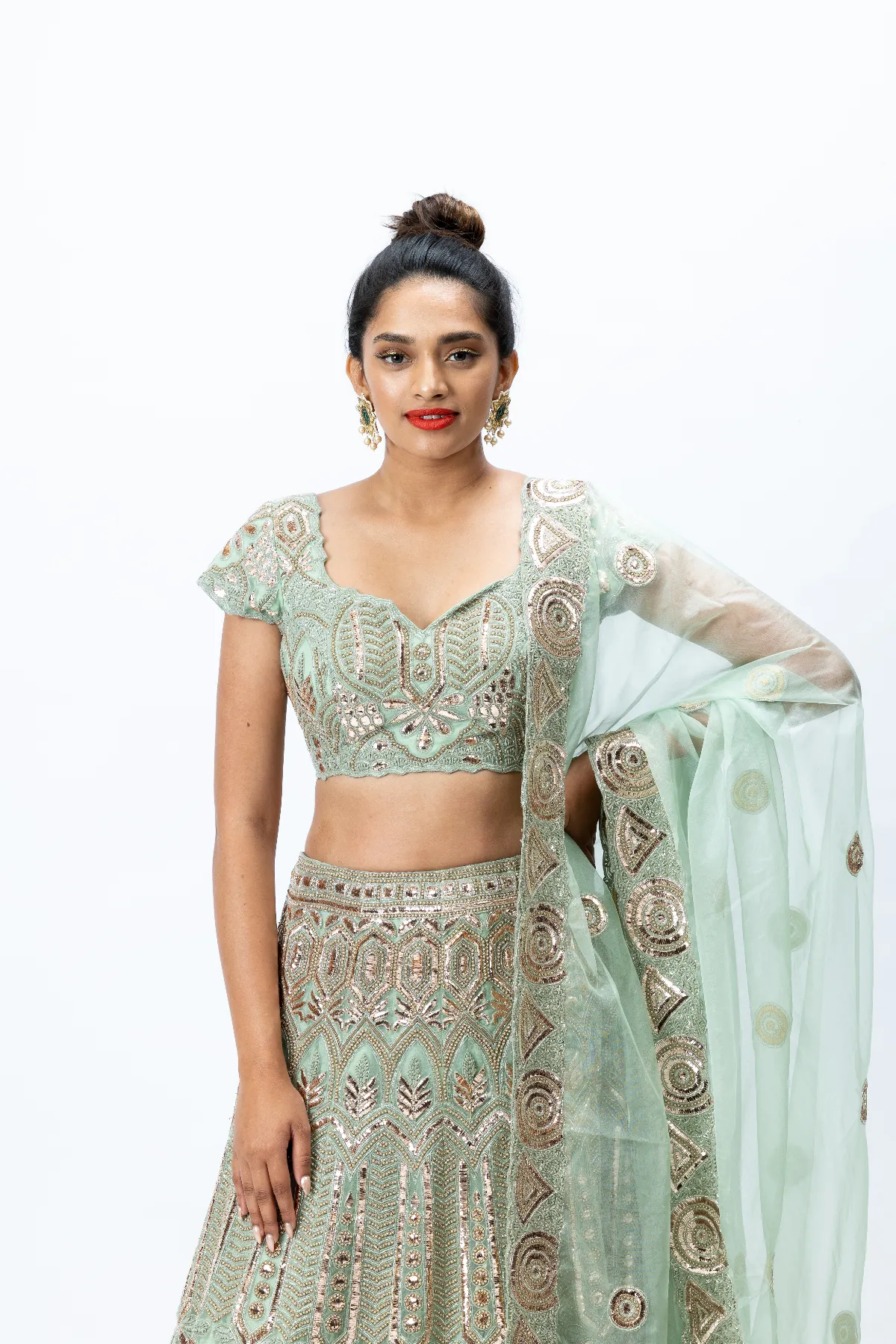 Mint Green Hand-embroidered Lehenga paired with Hand-embroidered Blouse, Hand-embroidered Dupatta and Hand-embroidered Long Jacket with Buttis